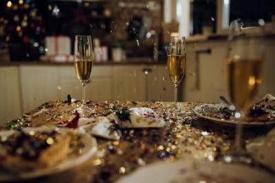 New Year’s Celebration with Confetti, Champagne Glasses, and Candlelight – Free Download