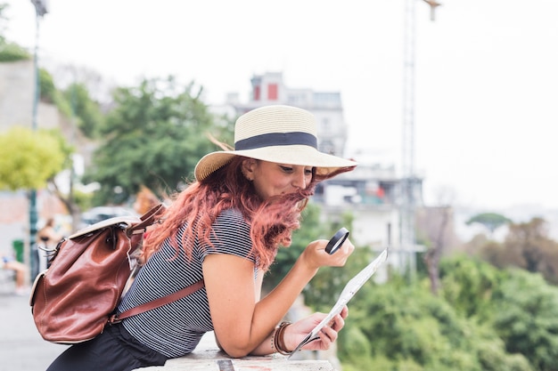 Female Tourist Examining a Map – Free Download