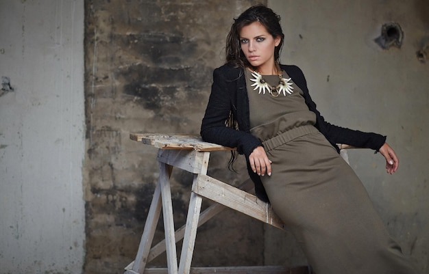 Elegant Woman Posing on Chair in Dark Green Dress – Free Stock Photo