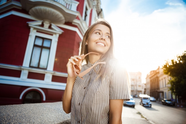 Cheerful Young Woman in Sunglasses Walking in the City – Free Stock Photo Download