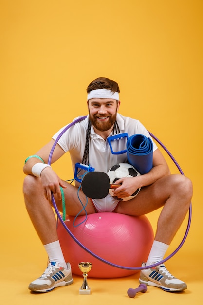 Cheerful Fitness Man Sitting on a Sports Ball – Free Stock Photo, Download Free