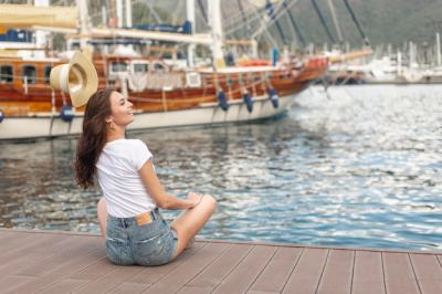 Cute Woman Sitting on the Shore of a Port – Free Stock Photo for Download