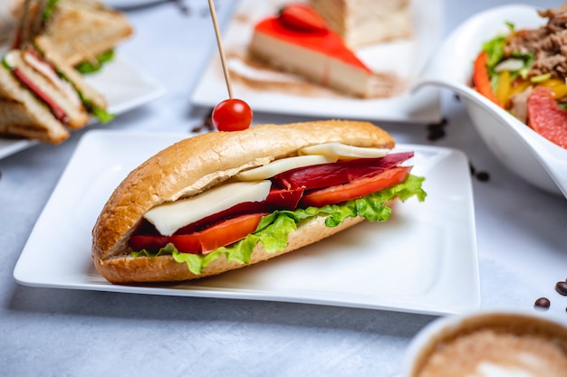 Side View of a Delicious Sandwich with Smoked Sausage, Cheese, Sliced Tomato, and Lettuce – Free to Download