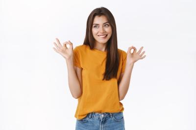 Cheerful Young Brunette Woman Smiling and Displaying Okay Sign – Free Stock Photo, Download for Free