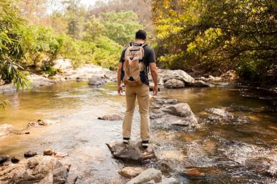 Man Standing on Stone at River – Free Stock Photo for Download