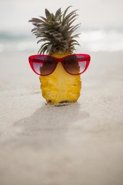 Halved Pineapple and Sunglasses on the Sand – Free Download