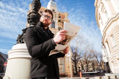 Handsome Man in Coat Holding Newspaper – Free Stock Photo, Download for Free