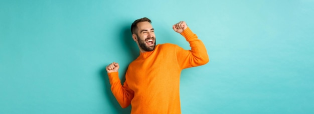 Happy Man Celebrating Victory with Joyful Pose – Free Stock Photo for Download