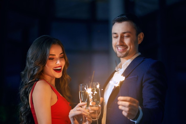 Happy Couple Celebrating Holiday with Sparklers – Free to Download