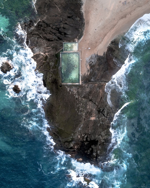 Aerial Shot of People Swimming in a Large Pool on the Rocky Coast of Thailand – Free to Download