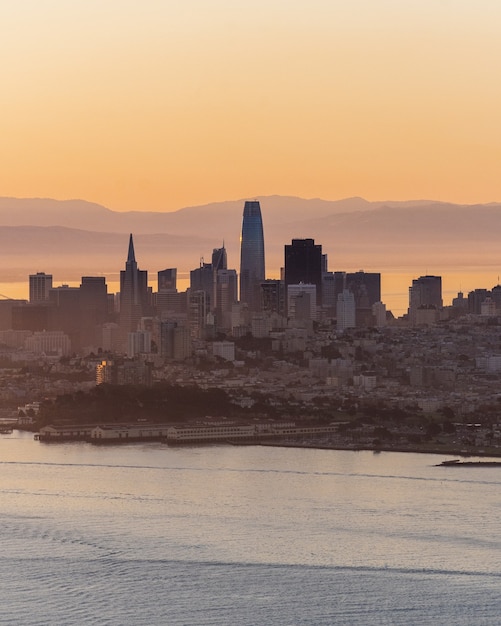 Vertical Shot of City Buildings Near the Sea – Free Stock Photo, Download Free