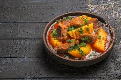 Tasty Meat Soup with Greens and Potatoes on Dark Desk – Free Download