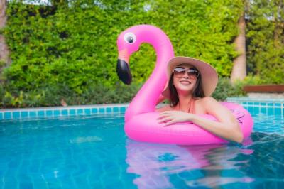 Happy Young Asian Woman Relaxing by Hotel Swimming Pool – Free to Download