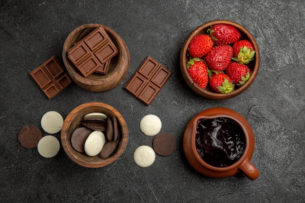 Chocolate Treats and Ingredients in Bowls on Dark Surface – Free Stock Photo for Download