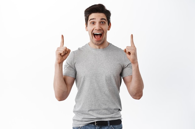 Handsome Man Expressing Joy and Pointing Up | Free Stock Photo for Download