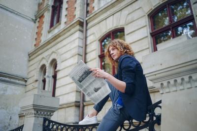 Young Reddish Man Reading Newspaper by Vintage Building – Free Stock Photo for Download