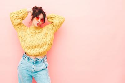 Young Beautiful Smiling Female in Trendy Summer Yellow Hipster Sweater and Jeans – Free Download