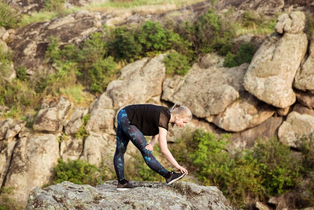 Beautiful Sportive Blonde Woman Training and Stretching in a Canyon – Free Stock Photo, Download Free