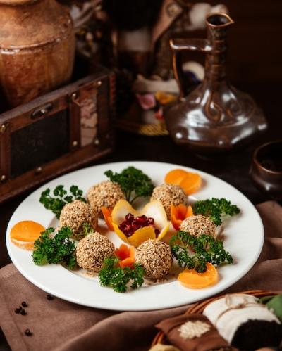 Meatballs Coated in Sesame Seeds with Herbs, Carrots, and Mandarin Slices – Free Download