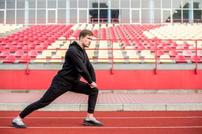 Young Male Athlete Warming Up in Stadium – Free Stock Photo for Download