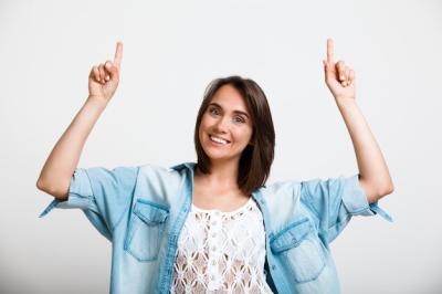 Young Enthusiastic Woman Pointing Up – Free Stock Photo for Download