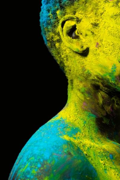 Close-Up of a Black Model Posing with Colorful Powder – Free Download