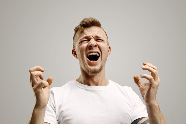 Screaming and Rage: Emotional Portrait of an Angry Man on Gray Background – Free Stock Photo for Download