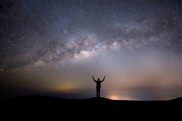 Silhouette of a Successful Man on a Hill Against a Starry Background – Free Stock Photo for Download