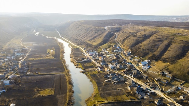 Aerial Drone Panorama of a Moldova Village Near River and Hills – Free Download