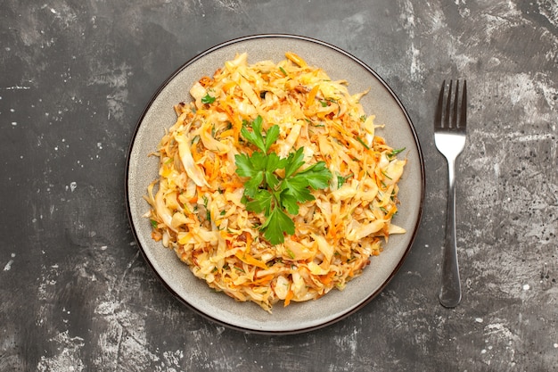 Appetizing Close-Up Dish of Cabbage, Carrots, and Herbs on Dark Background – Free Download