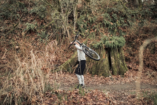 Man Carrying Bicycle on His Back in the Forest – Free Stock Photo, Download for Free