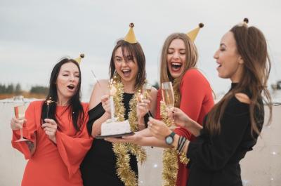 Gorgeous Girls Holding a Birthday Cake at a Rooftop Party – Free Download