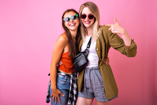 Cheerful Portrait of Two Stylish Women Posing Together – Free Download