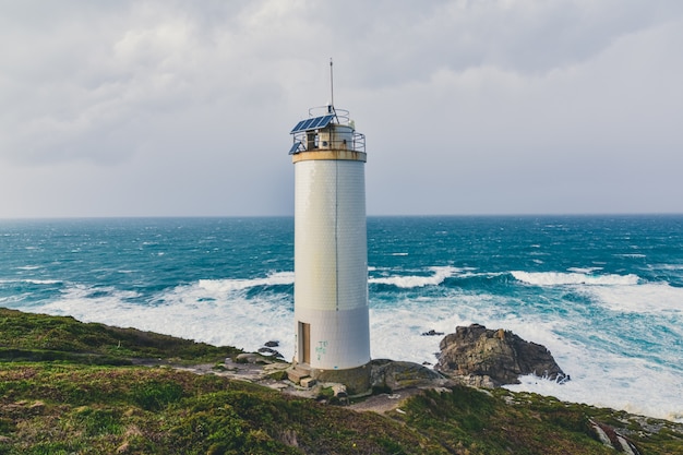 Stunning Cliffs and a Majestic Lighthouse by the Stormy Sea – Free Download