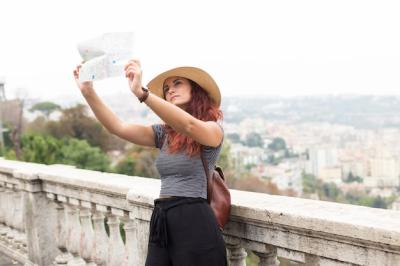 Female Tourist Examining Map – Free Download