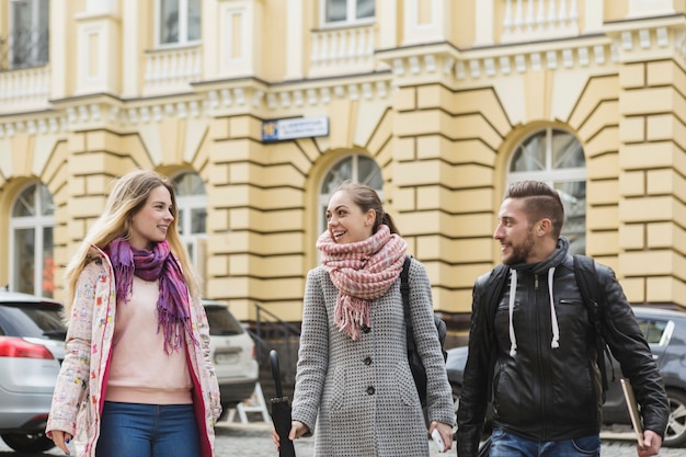 Cheerful Man and Women Walking on Street – Free Stock Photo for Download