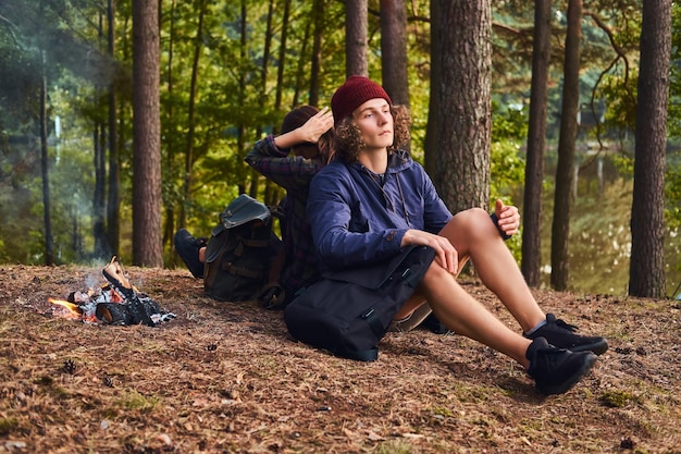 Young Hipster Couple Hiking in the Forest near a Campfire – Free Stock Photo for Download