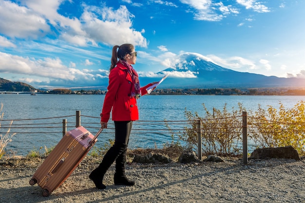 Tourist in Kawaguchiko, Japan with Baggage and Map at Fuji Mountain – Free Download