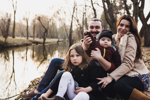 Family Posing on the Shore of a Lake – Free Download