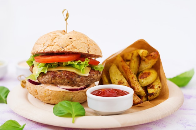 Juicy Beef Hamburger with Cheese, Tomato, Red Onion, and French Fries – Free Stock Photo for Download