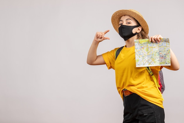 Young Woman with Backpack Holding Map – Free Stock Photo for Download