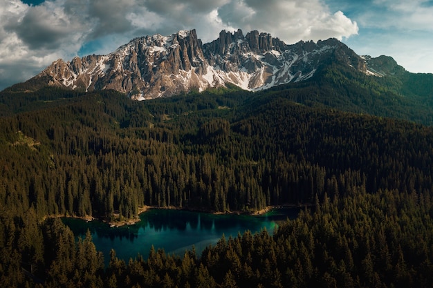 Karersee in the Dolomites: Scenic Views of Forests and Cloudy Skies – Free Download