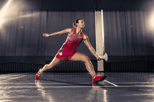 Young Woman Playing Badminton at the Gym – Free Download