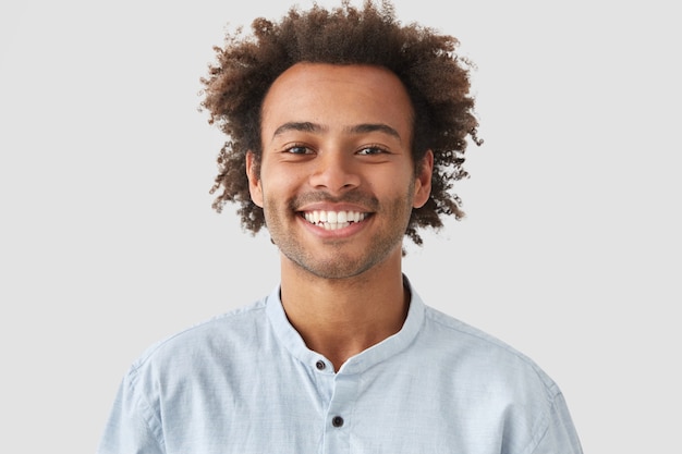 Young Man with Curly Hair in a Shirt – Free Stock Photo for Download