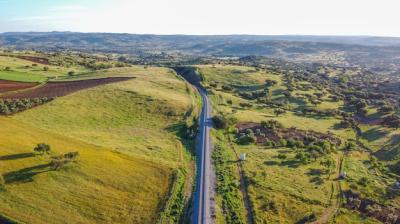 Aerial View of Vast Farmland with a Country Road – Free to Download