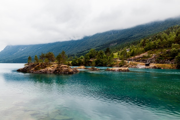 Stunning Green Mountains Reflected in an Idyllic Blue Lake – Free Download