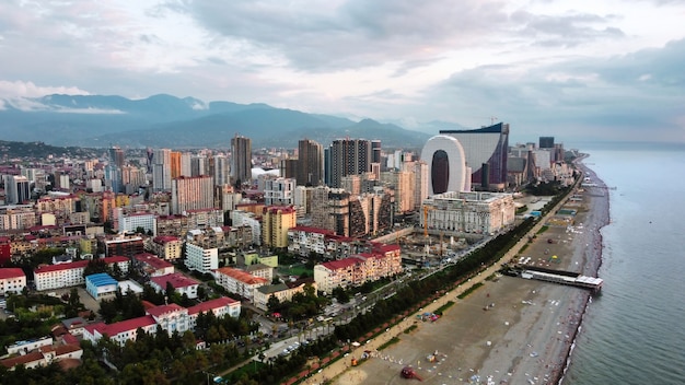 Aerial Drone View of Batumi Coastline with Black Sea, Buildings, Greenery, and Mountains – Free Download