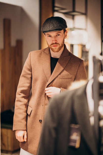 Young Handsome Man Choosing Hat at the Shop – Free Stock Photo for Download