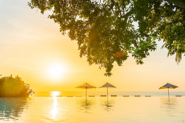 Stunning Outdoor Swimming Pool in Hotel Resort with Umbrella and Deck Chair – Free Download