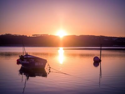 Stunning Sunset Over the River with an Old Fishing Boat – Free Download